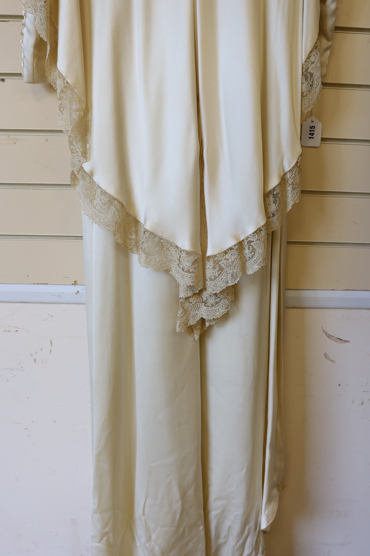 A 1970's cream satin wedding dress, trimmed with 19th century point de gaze, hand made needlepoint lace